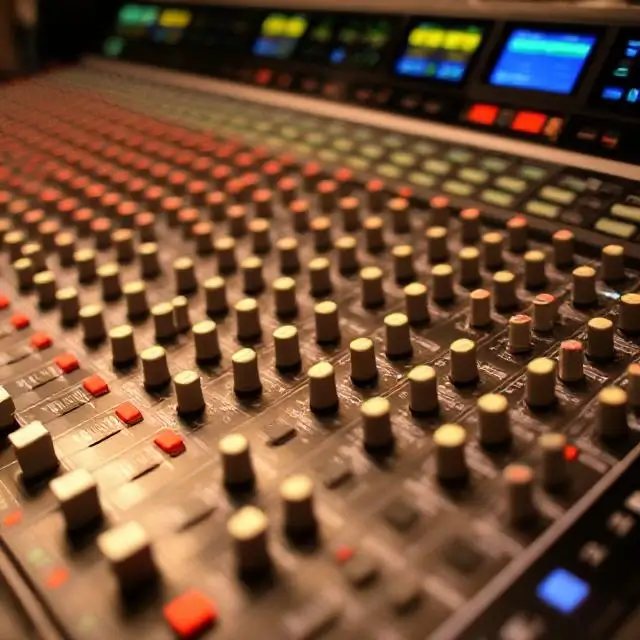 Close-up of a complex audio mixing console